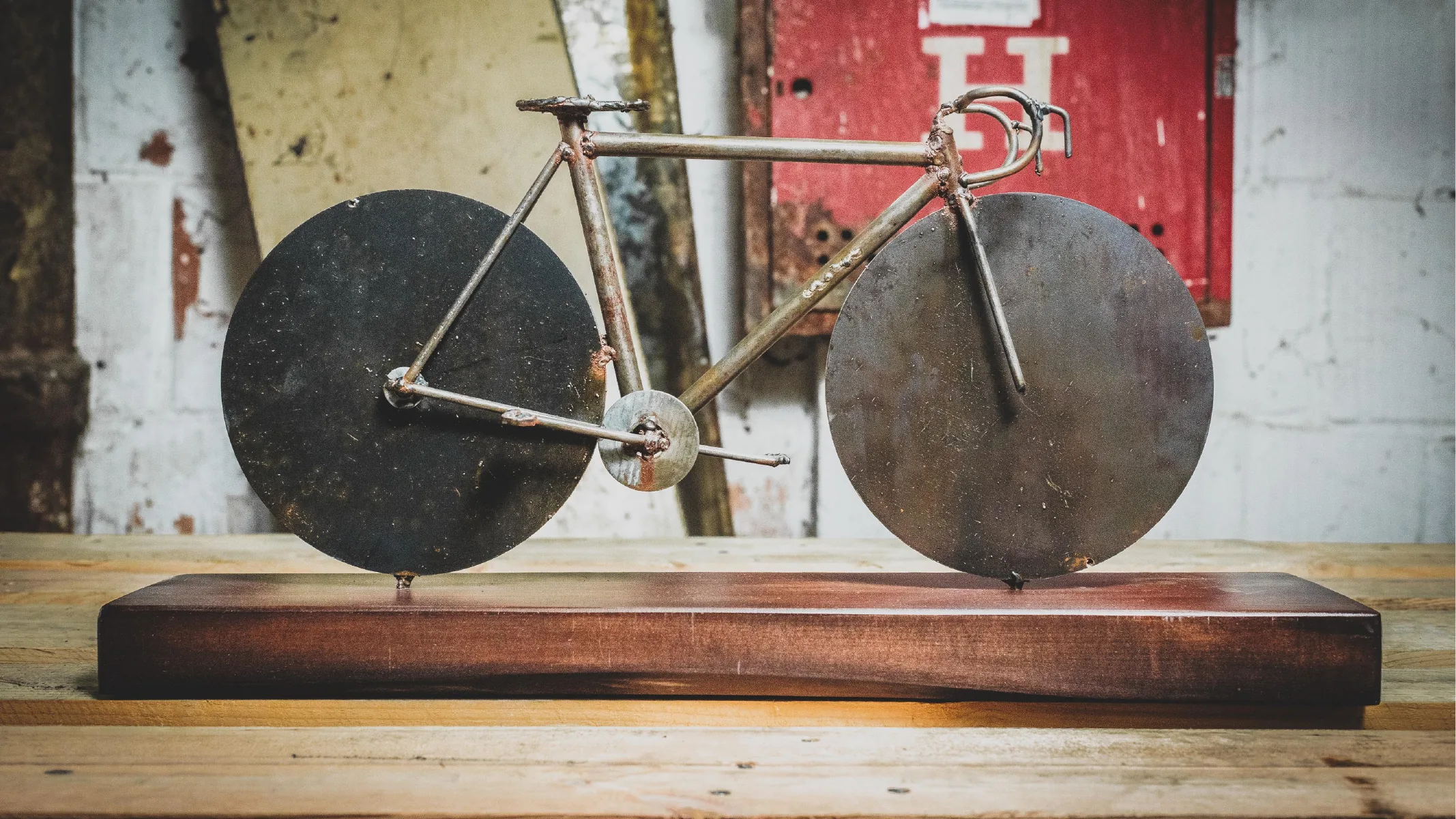 Minimal bicycle sculpture on a wooden base