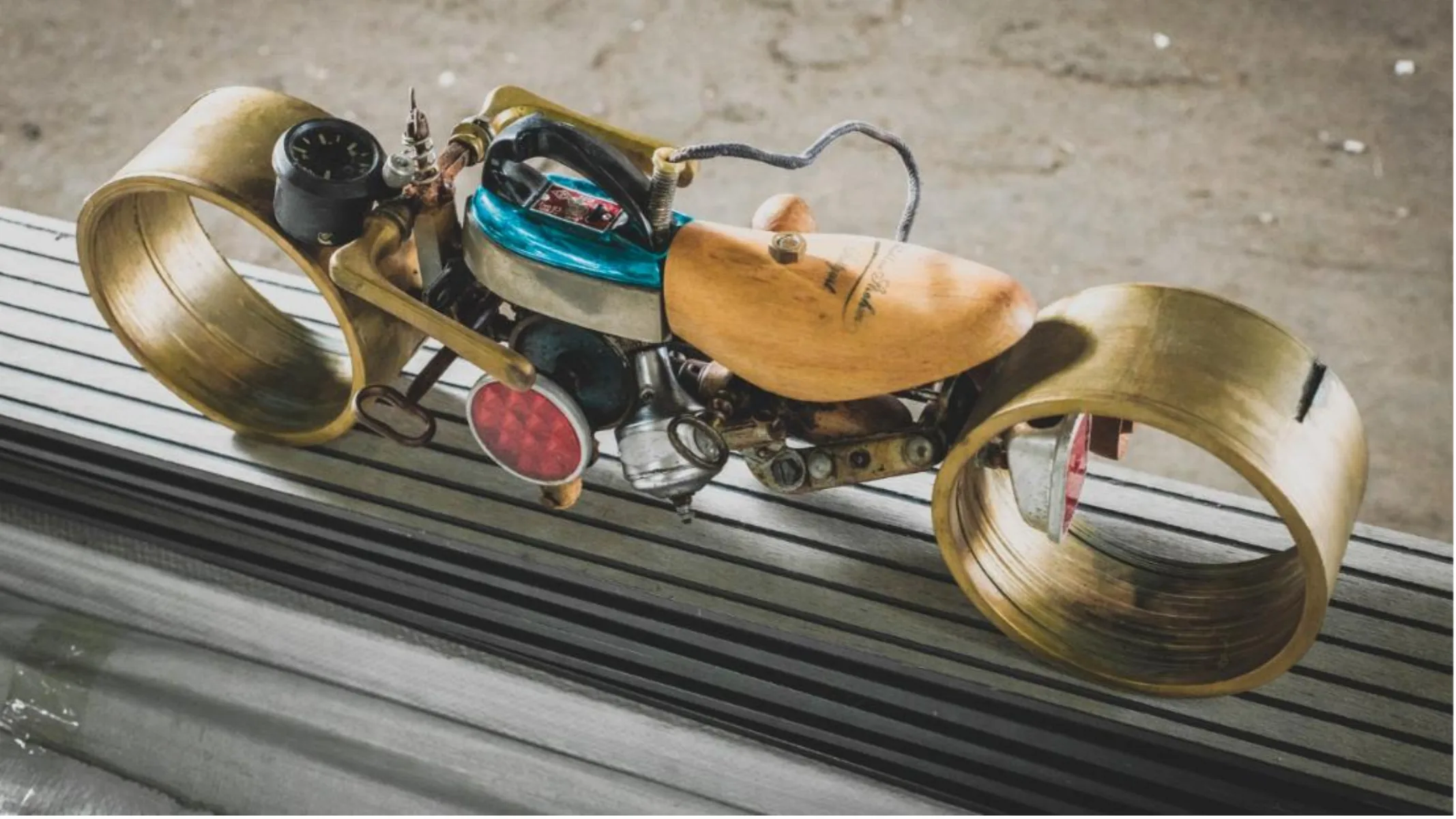 Colorful motorcycle sculpture with brass details