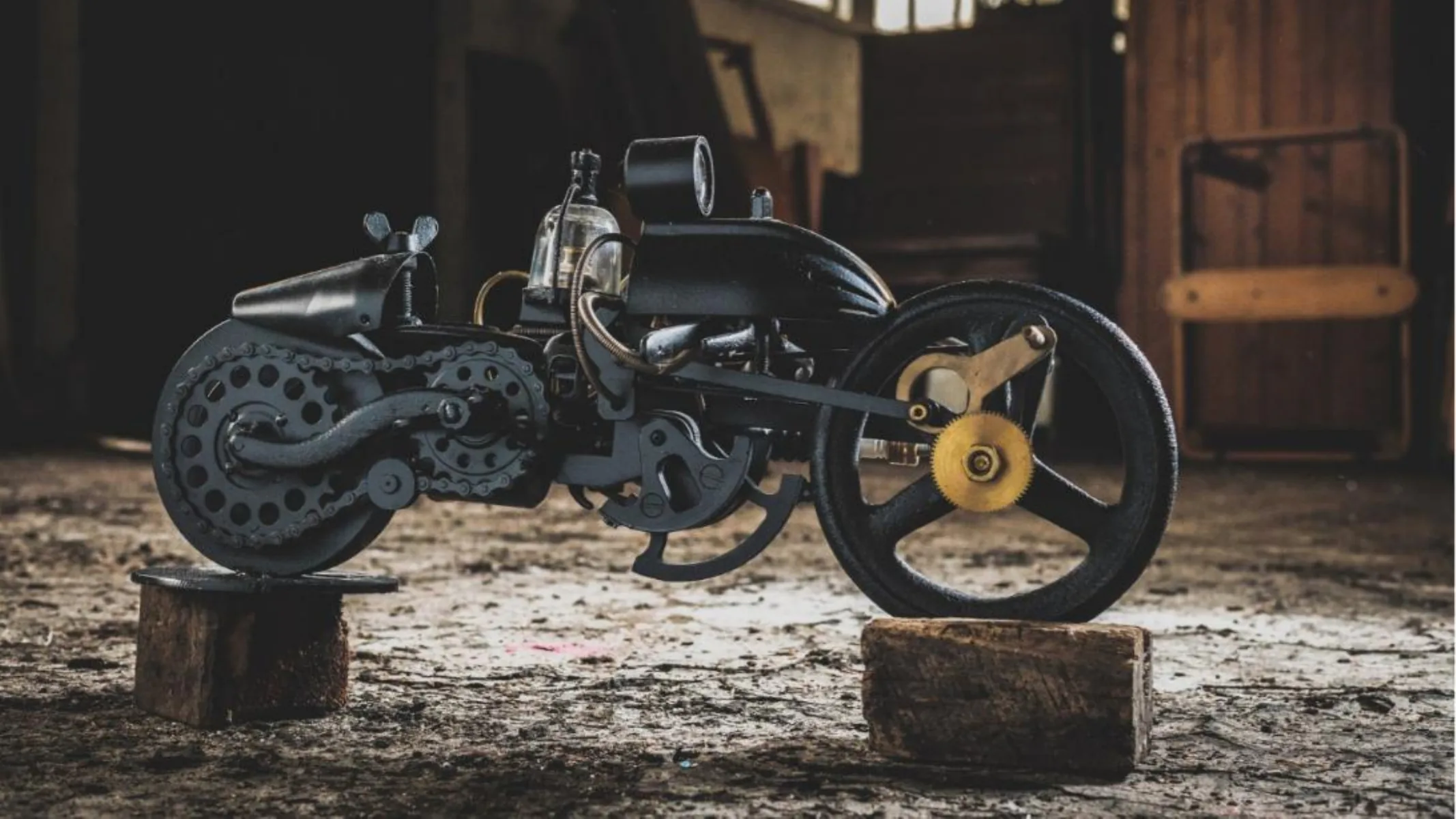 Dark motorcycle sculpture with textured wheels